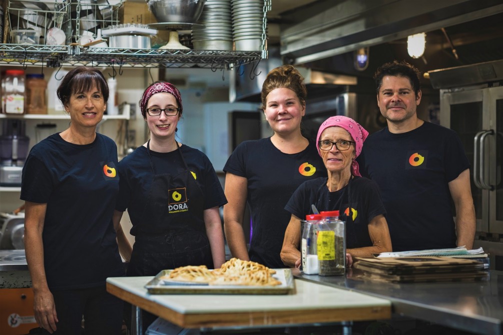Dora's Team: The Dora team is comprised of a dozen employees - a small group is produced in this photo, including the donut chef, the pastry chef, the kitchen chef and the owner.